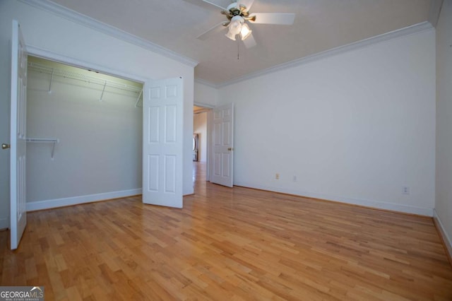 unfurnished bedroom featuring a closet, baseboards, crown molding, and light wood finished floors