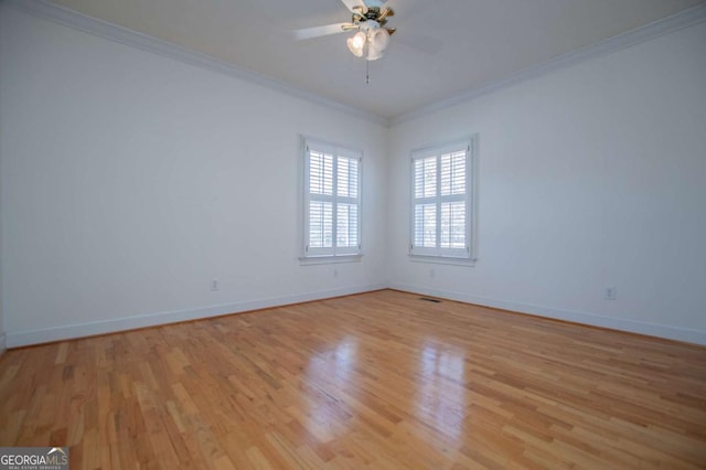 unfurnished room featuring light wood-style floors, a ceiling fan, baseboards, and crown molding