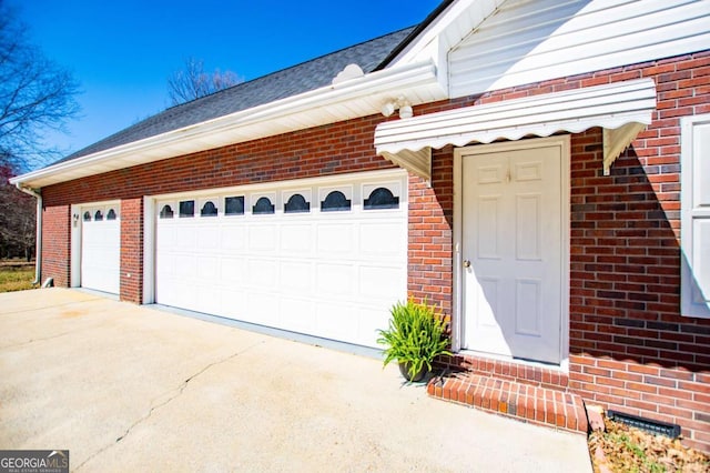 garage with concrete driveway