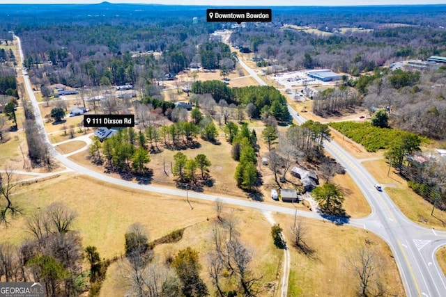 drone / aerial view featuring a wooded view