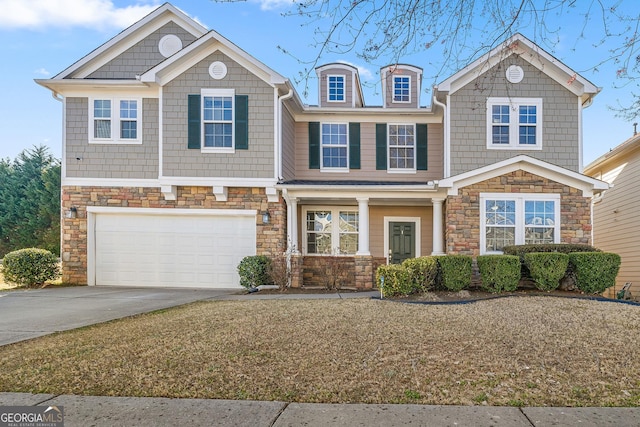 view of front of house featuring a garage, stone siding, and concrete driveway