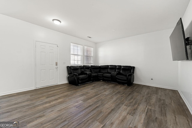 living area featuring visible vents, baseboards, and wood finished floors