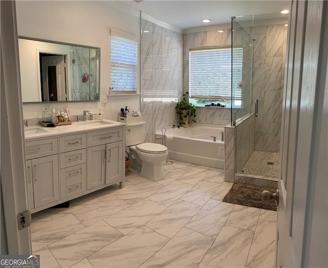 full bath with a sink, marble finish floor, a shower stall, a bath, and double vanity