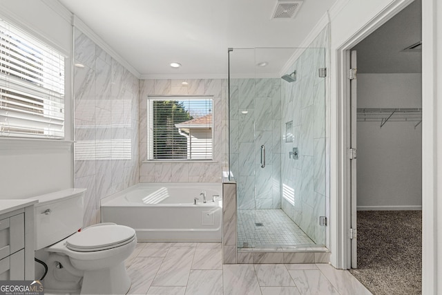 bathroom with a garden tub, crown molding, visible vents, a stall shower, and vanity