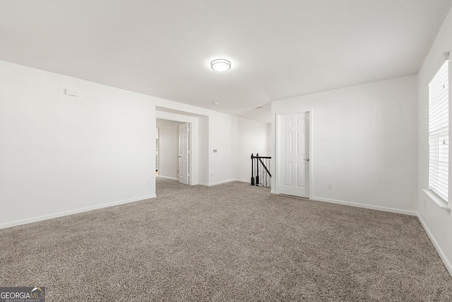 carpeted empty room with baseboards