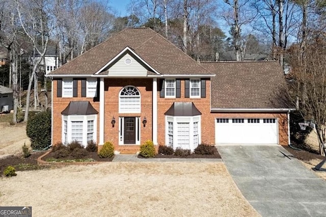 view of front facade featuring aphalt driveway, brick siding, a garage, and roof with shingles