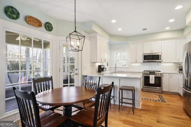 dining room featuring visible vents, recessed lighting, and light wood-type flooring