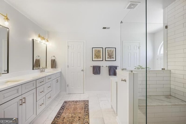 bathroom featuring a sink, visible vents, marble finish floor, and double vanity