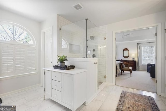 full bath with visible vents, a shower stall, ensuite bathroom, and baseboards