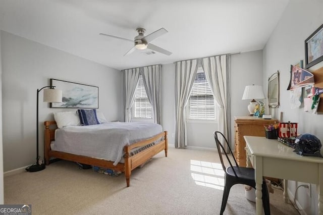 bedroom featuring visible vents, light carpet, baseboards, and a ceiling fan