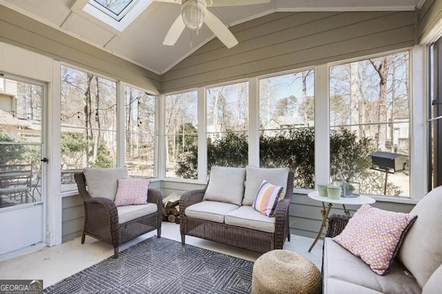 sunroom featuring lofted ceiling with skylight and ceiling fan