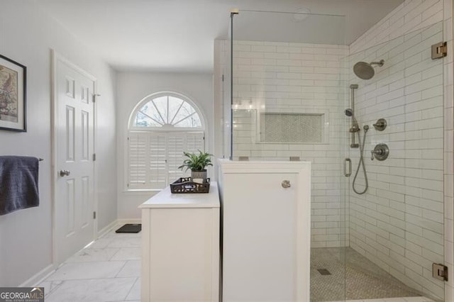 full bathroom with baseboards and a stall shower