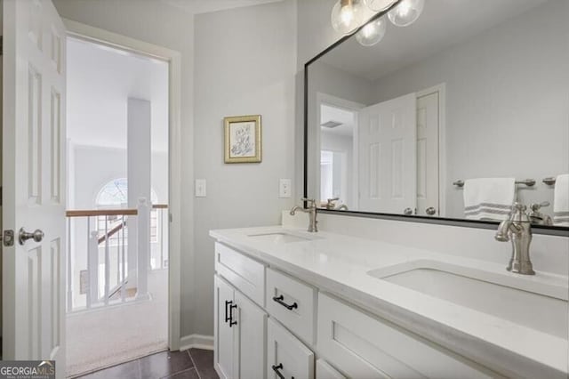 bathroom with double vanity, tile patterned flooring, and a sink