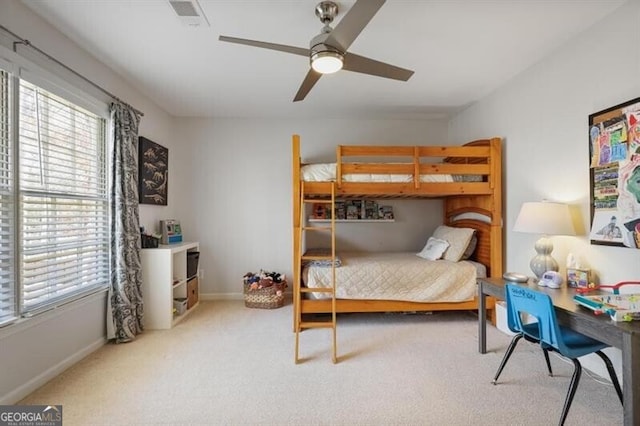 bedroom with carpet flooring, baseboards, visible vents, and a ceiling fan