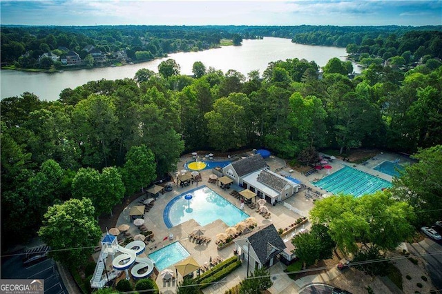 drone / aerial view featuring a view of trees and a water view