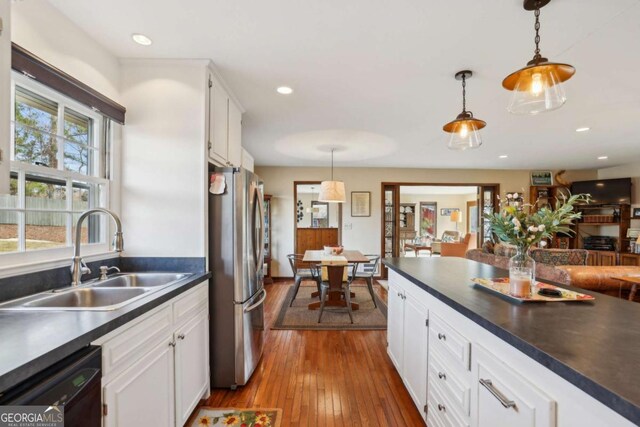 living area with recessed lighting, a brick fireplace, and light colored carpet