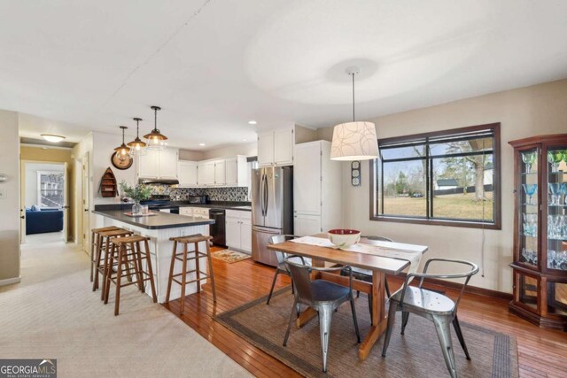 carpeted living room featuring a fireplace, visible vents, and recessed lighting