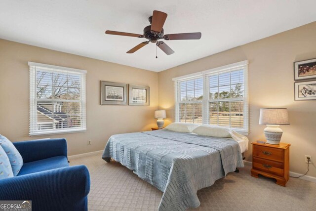 carpeted bedroom featuring baseboards and ceiling fan