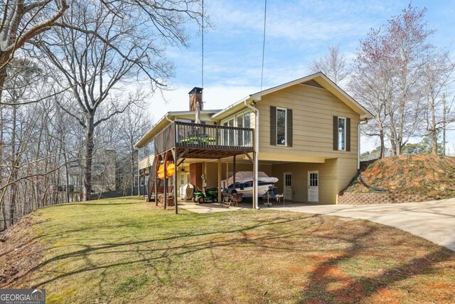 back of property with stairway, a deck, and a lawn