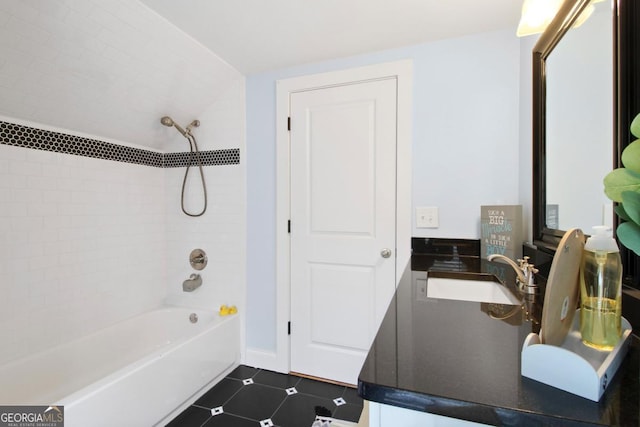 bathroom featuring tile patterned floors, a sink, and shower / bathtub combination