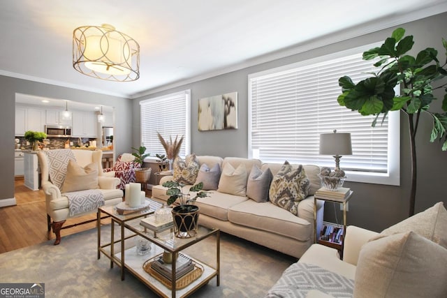 living room featuring light wood-style floors and crown molding