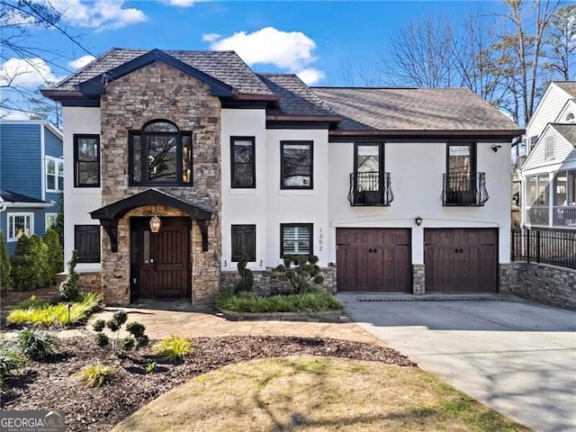 view of front of property featuring driveway, an attached garage, and stucco siding