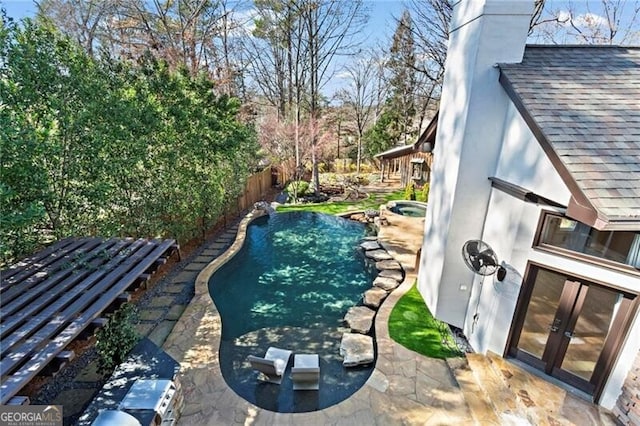 view of pool featuring a patio area, a fenced backyard, a fenced in pool, and french doors