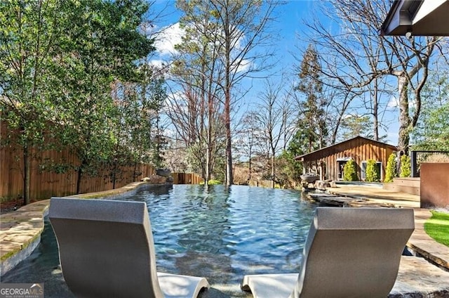 view of swimming pool with a fenced backyard