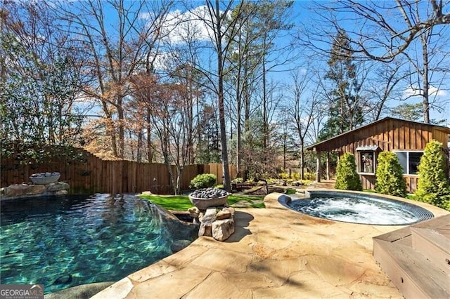 view of pool with a swimming pool, a patio area, fence, and an outdoor hot tub