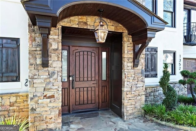 doorway to property with stone siding