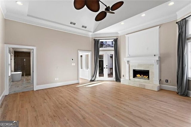 unfurnished living room featuring ornamental molding, light wood-type flooring, and baseboards