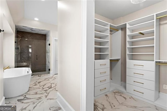 walk in closet with marble finish floor