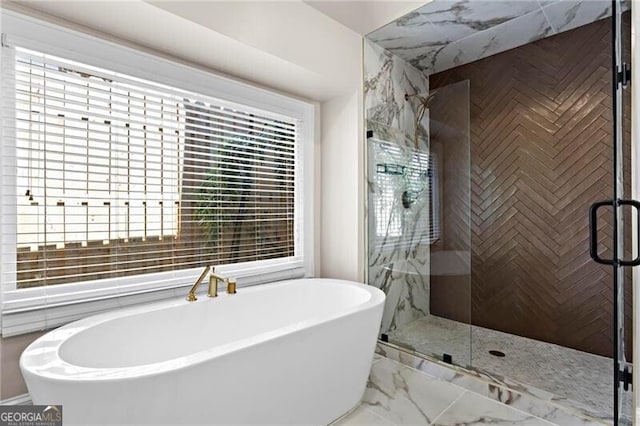 full bath featuring marble finish floor, a shower stall, and a freestanding bath