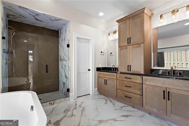 bathroom featuring marble finish floor, a shower stall, a freestanding bath, and a sink