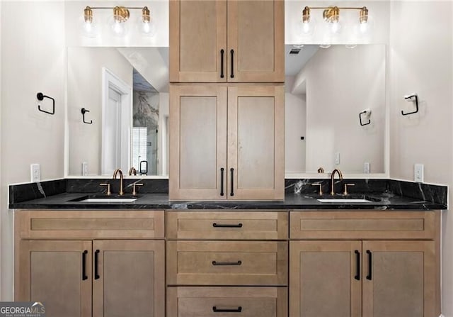 full bathroom featuring double vanity, visible vents, and a sink