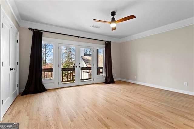 unfurnished room with french doors, crown molding, light wood finished floors, visible vents, and baseboards