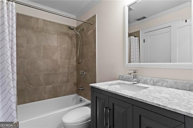 bathroom with toilet, vanity, visible vents, and crown molding