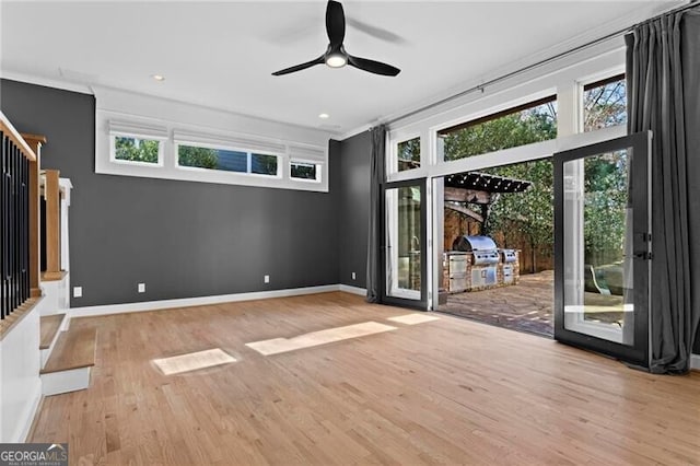 unfurnished living room with baseboards, ceiling fan, wood finished floors, stairs, and recessed lighting