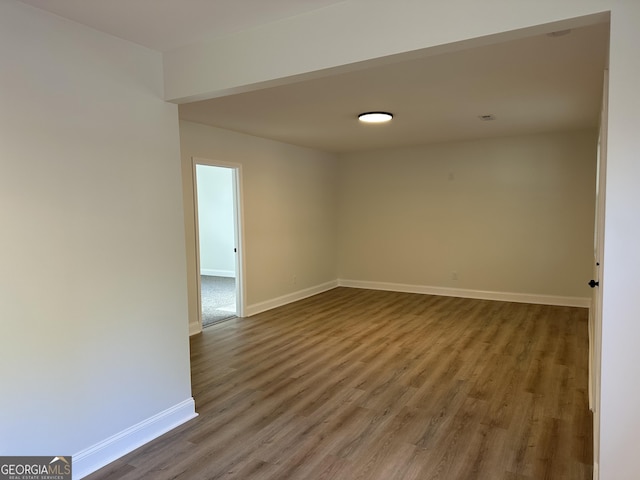 empty room with wood finished floors and baseboards