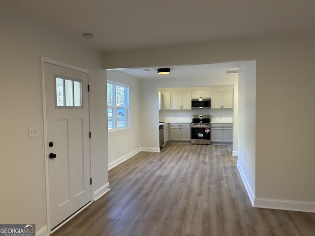 interior space featuring visible vents, baseboards, and wood finished floors