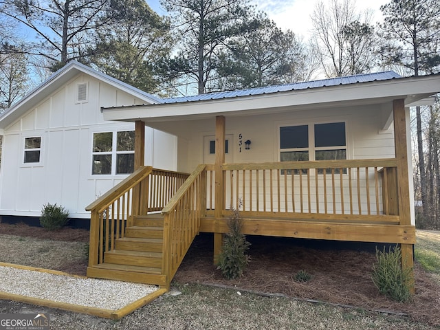 view of front of home with board and batten siding and metal roof