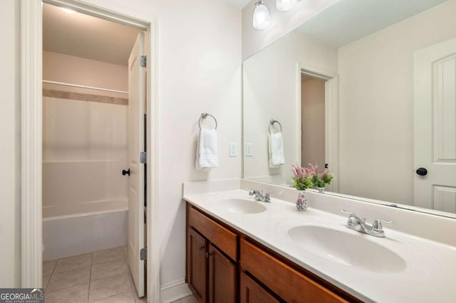 full bath featuring bathtub / shower combination, double vanity, a sink, and tile patterned floors