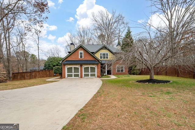 view of front of house with brick siding, fence, concrete driveway, a chimney, and a front yard