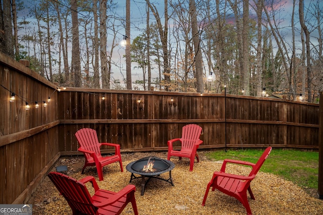 view of patio with a fenced backyard and a fire pit