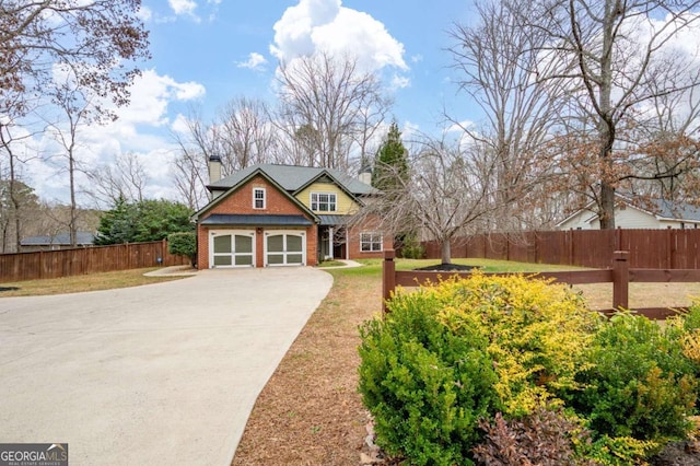 view of front of house with a garage, concrete driveway, a chimney, fence, and brick siding