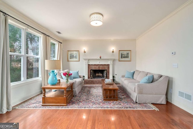 living room with a fireplace, wood finished floors, and visible vents