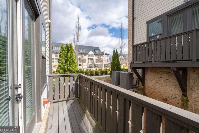 balcony with central AC and a residential view