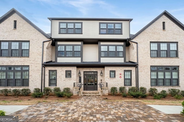 doorway to property with brick siding