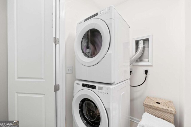 washroom featuring laundry area and stacked washer / dryer