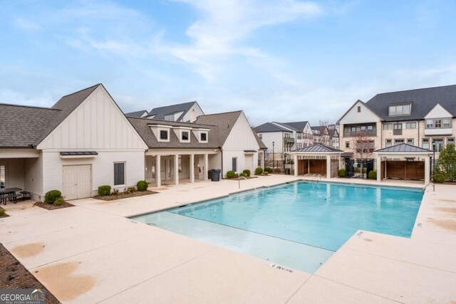 pool featuring a patio, a gazebo, and fence